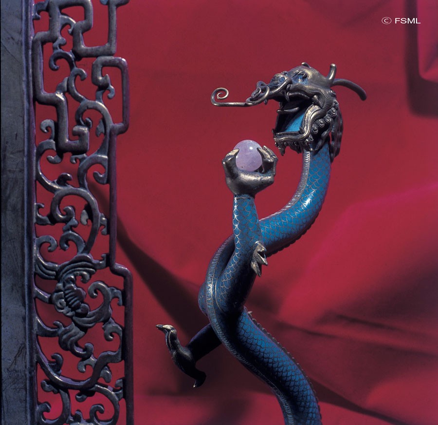 A beautifully stylised serpent dragon with a pearl held in its claws